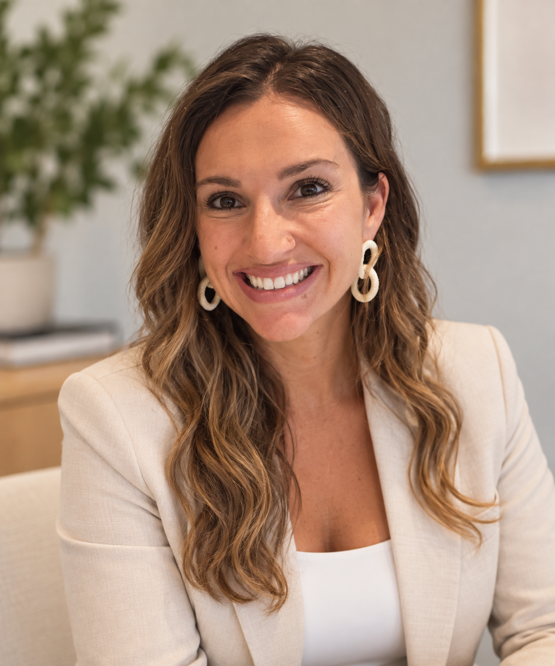 Portrait of Rachayl smiling indoors in a light blazer
